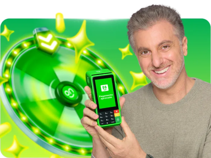 banner maquinas ton, luciano huck segurando uma maquina ton